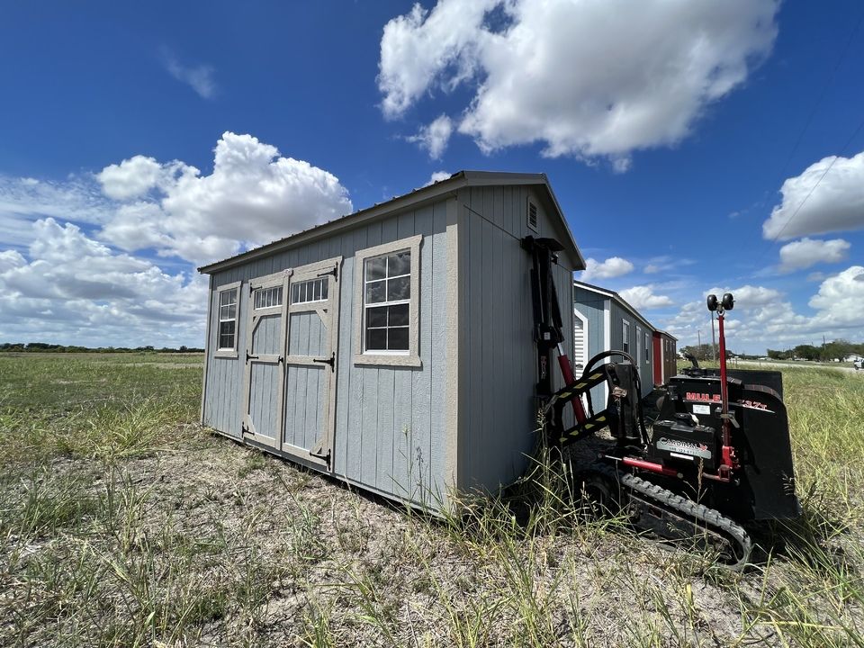 Shed being moved into place with delivery equipment
